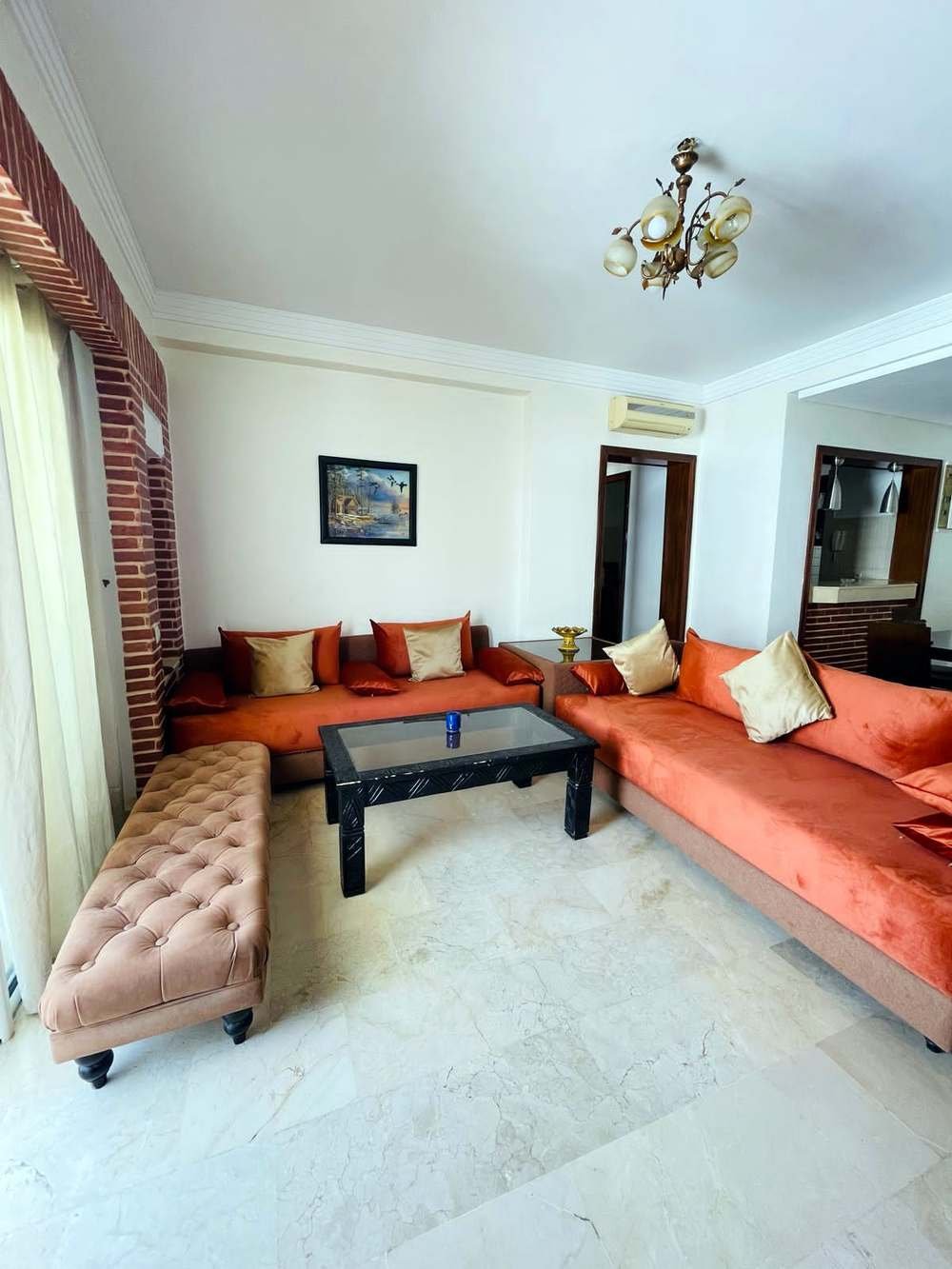 Apartment, orange living room and brick wall